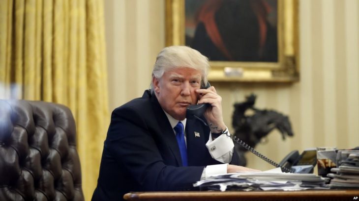 President Donald Trump speaks on the phone with Prime Minister of Australia Malcolm Turnbull in the Oval Office of the White House, Saturday, Jan. 28, 2017 in Washington. (AP Photo/Alex Brandon)
