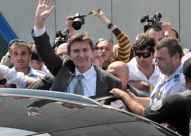 Former Bosnian leader Ejup Ganic waves on arrival to Sarajevo International Airport on July 28, 2010, after travelling from Britain following a British court's rejection of a Serbian bid to have him extradited on war crimes charges. Ganic was arrested at London's Heathrow airport in March as Serbia sought his extradition on charges of ordering a series of atrocities in Sarajevo in May 1992, at the outset of the three-and-a-half year Bosnian war. AFP PHOTO ELVIS BARUKCIC (Photo credit should read ELVIS BARUKCIC/AFP/Getty Images)