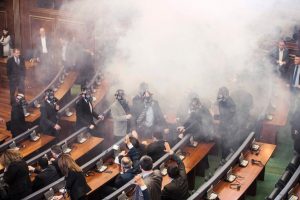 Kosovo police officers wearing gas masks inspect the parliament, after tear gas was launched by opposition lawmakers, disrupting the first parliamentary session of the year in Pristina on Feb. 19, 2016. Angry over a government deal with Serbia and demanding snap elections, the united opposition has effectively blocked parliamentary proceedings since October with their tear gas protests.